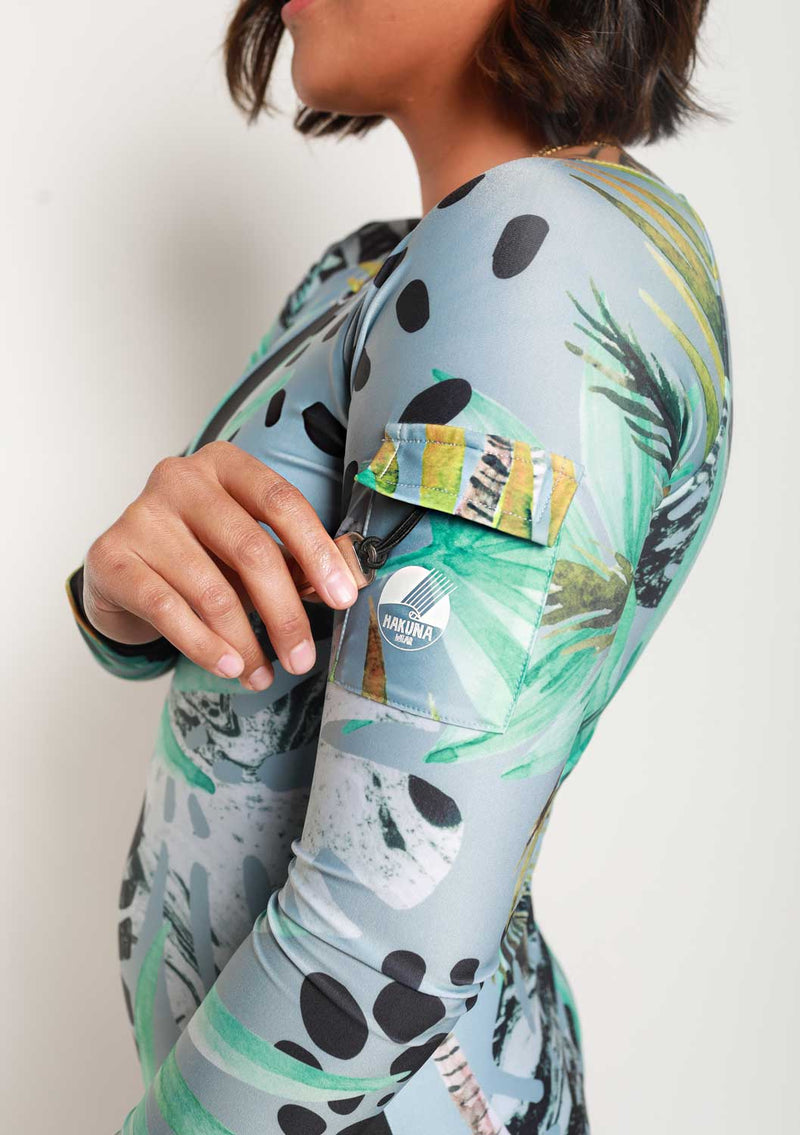  Woman wearing Hakuna Long Sleeve Surf Suit in Radical Tropical print